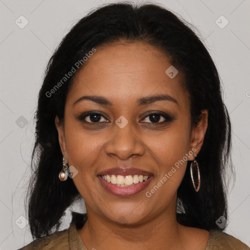 Joyful black young-adult female with long  black hair and brown eyes