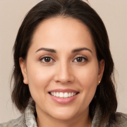 Joyful white young-adult female with medium  brown hair and brown eyes