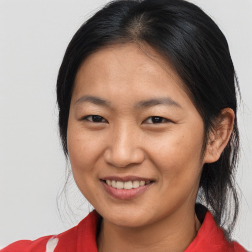Joyful asian young-adult female with medium  black hair and brown eyes
