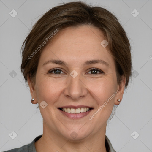 Joyful white adult female with medium  brown hair and grey eyes