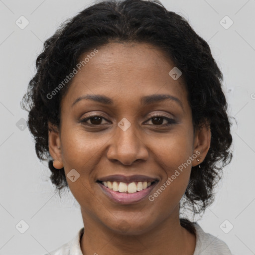 Joyful black young-adult female with short  brown hair and brown eyes