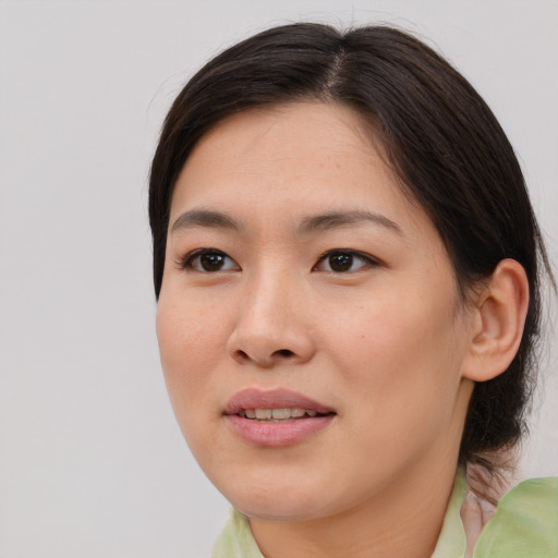 Joyful asian young-adult female with medium  brown hair and brown eyes
