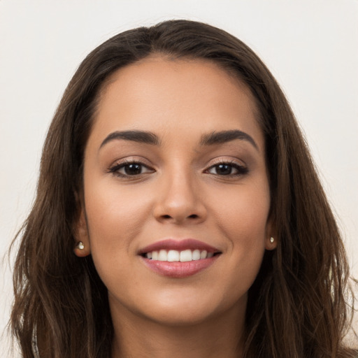 Joyful white young-adult female with long  brown hair and brown eyes