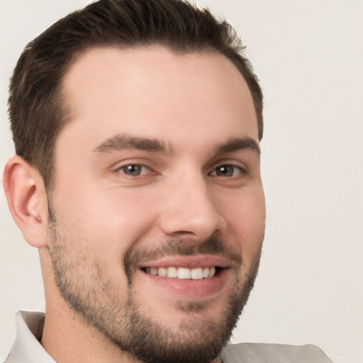 Joyful white young-adult male with short  brown hair and brown eyes