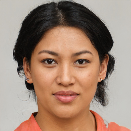 Joyful latino young-adult female with medium  brown hair and brown eyes