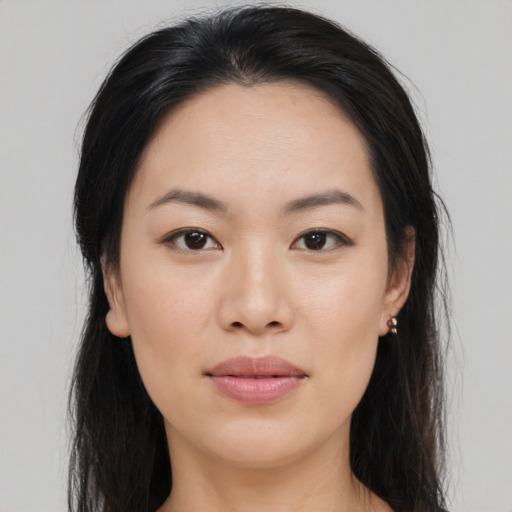 Joyful asian young-adult female with long  brown hair and brown eyes