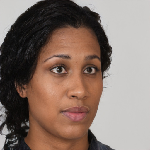 Neutral black young-adult female with long  brown hair and brown eyes