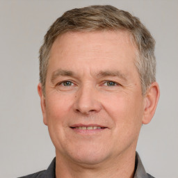 Joyful white adult male with short  brown hair and grey eyes