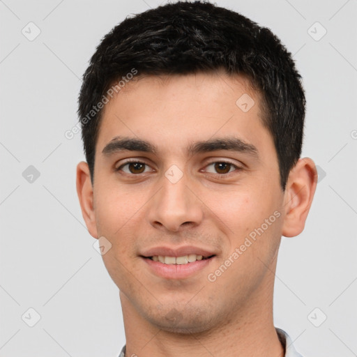 Joyful white young-adult male with short  black hair and brown eyes