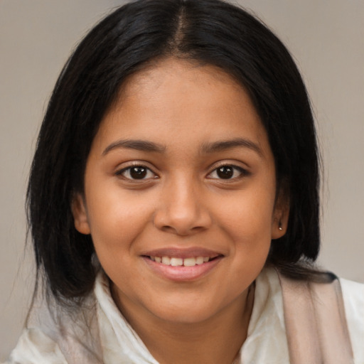 Joyful latino young-adult female with medium  brown hair and brown eyes