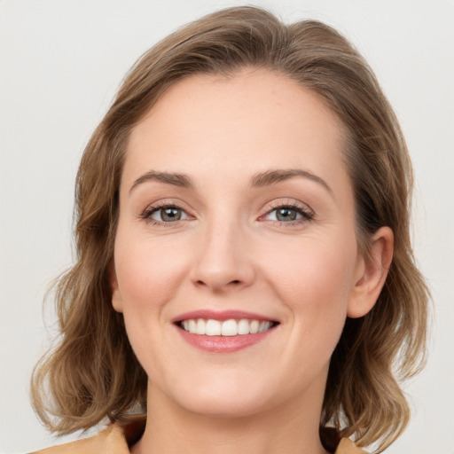 Joyful white young-adult female with medium  brown hair and green eyes