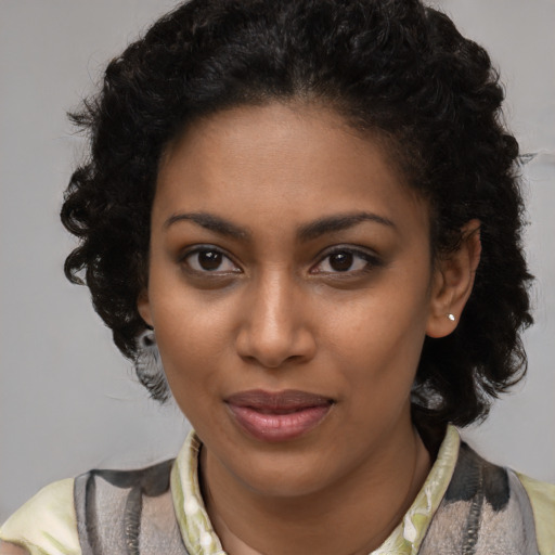 Joyful black young-adult female with medium  brown hair and brown eyes
