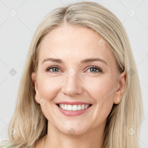 Joyful white young-adult female with long  brown hair and blue eyes