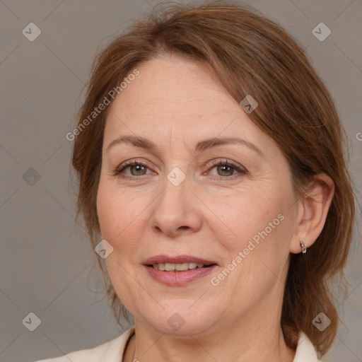 Joyful white adult female with medium  brown hair and grey eyes