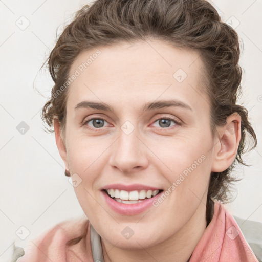 Joyful white young-adult female with medium  brown hair and blue eyes