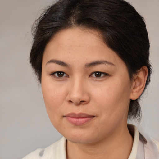 Joyful asian young-adult female with medium  brown hair and brown eyes