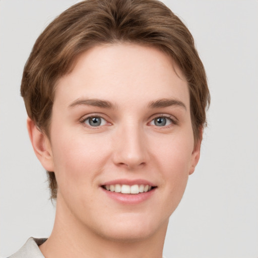 Joyful white young-adult female with short  brown hair and grey eyes