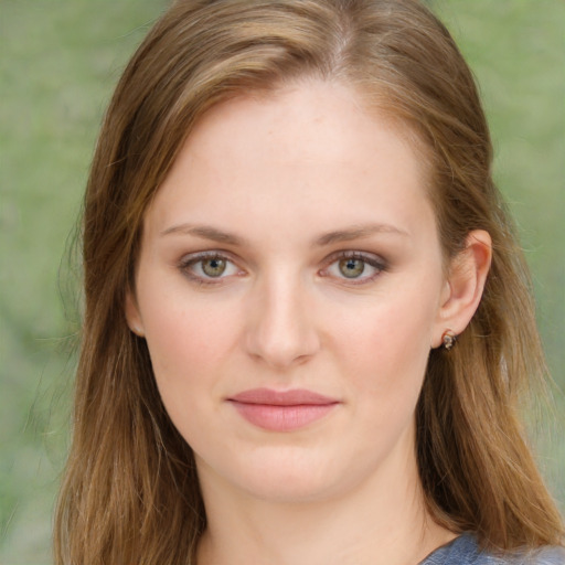 Joyful white young-adult female with long  brown hair and green eyes