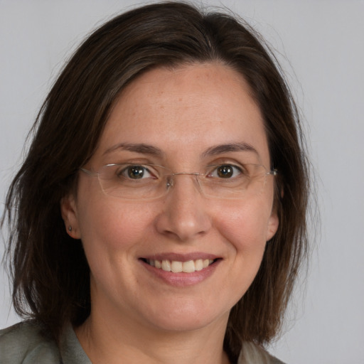 Joyful white adult female with medium  brown hair and brown eyes