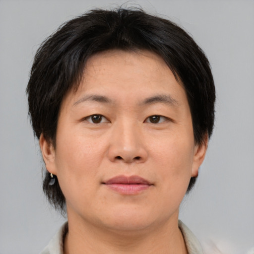 Neutral asian adult female with short  brown hair and brown eyes