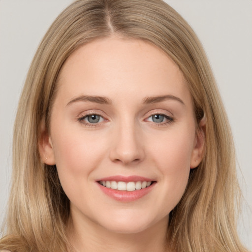 Joyful white young-adult female with long  brown hair and grey eyes