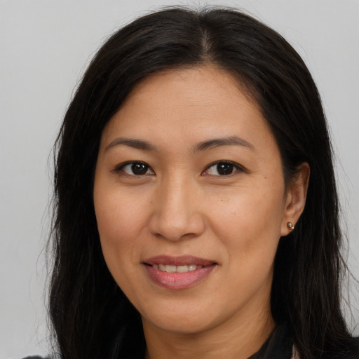 Joyful asian adult female with long  brown hair and brown eyes