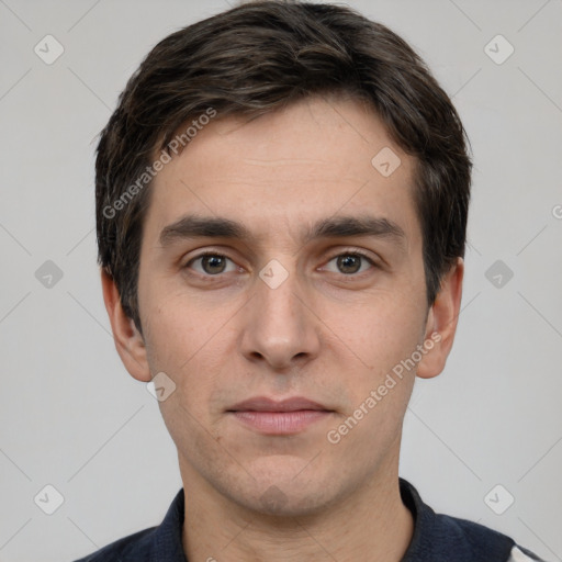 Joyful white young-adult male with short  black hair and brown eyes