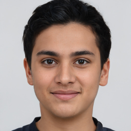 Joyful latino young-adult male with short  brown hair and brown eyes