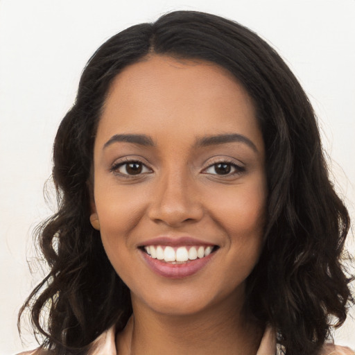 Joyful latino young-adult female with long  brown hair and brown eyes