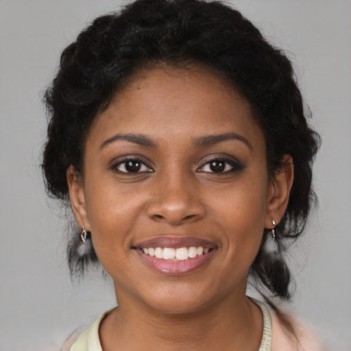 Joyful black young-adult female with medium  brown hair and brown eyes