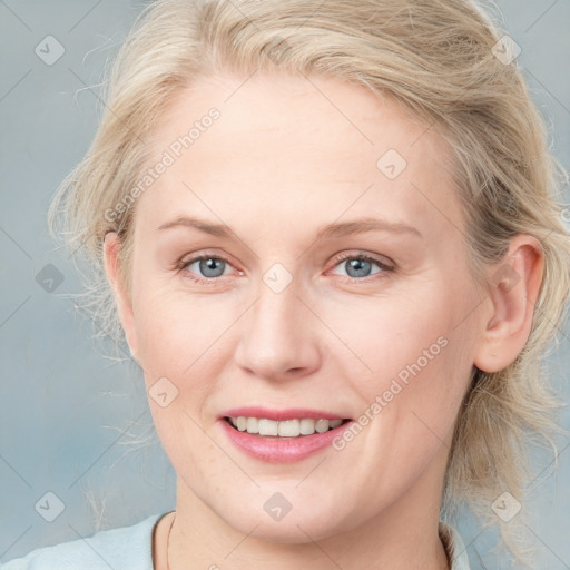 Joyful white adult female with medium  brown hair and blue eyes