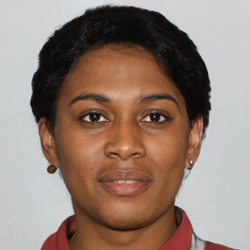 Joyful latino young-adult female with short  black hair and brown eyes