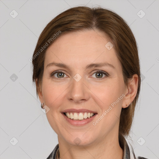 Joyful white adult female with medium  brown hair and grey eyes