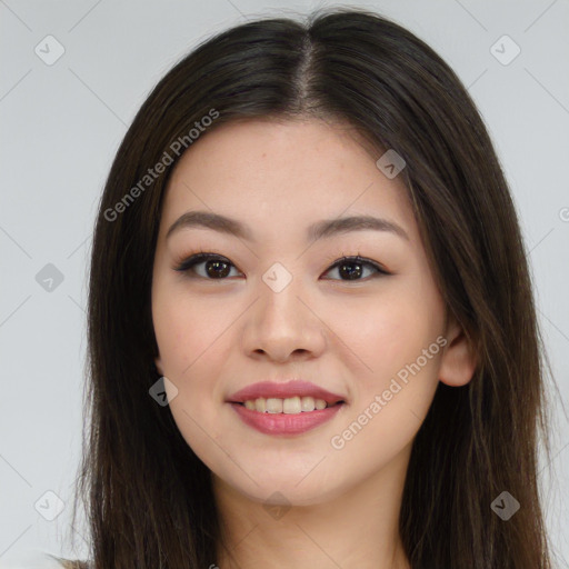 Joyful asian young-adult female with long  brown hair and brown eyes