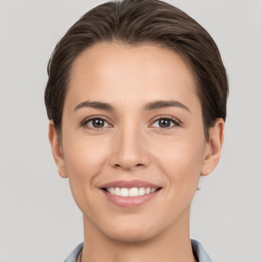 Joyful white young-adult female with short  brown hair and brown eyes