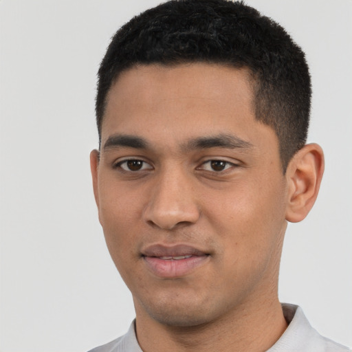 Joyful latino young-adult male with short  black hair and brown eyes