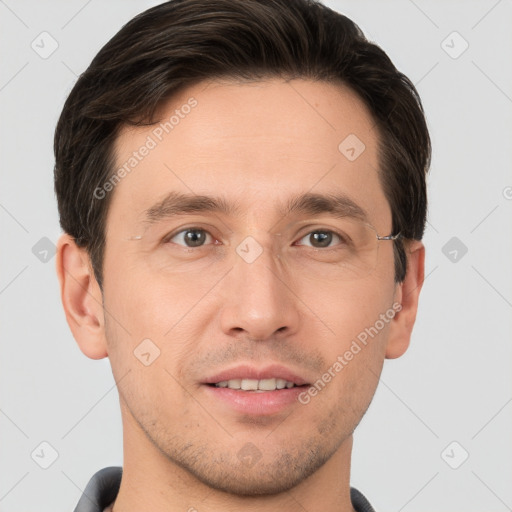 Joyful white young-adult male with short  brown hair and grey eyes