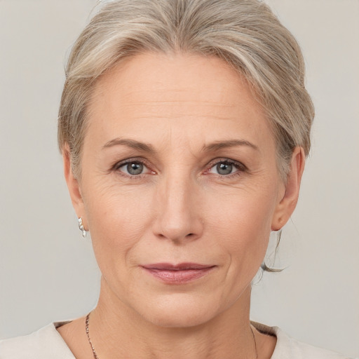 Joyful white adult female with medium  blond hair and grey eyes