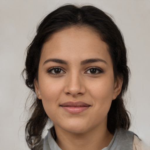 Joyful latino young-adult female with medium  brown hair and brown eyes