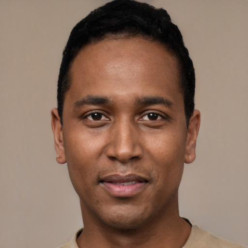 Joyful black young-adult male with short  black hair and brown eyes