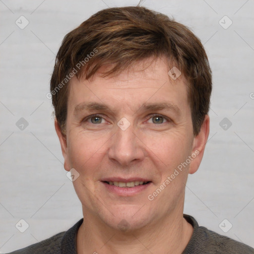 Joyful white adult male with short  brown hair and grey eyes