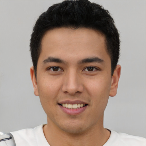 Joyful latino young-adult male with short  brown hair and brown eyes