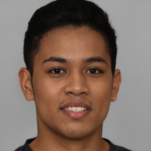 Joyful latino young-adult male with short  brown hair and brown eyes