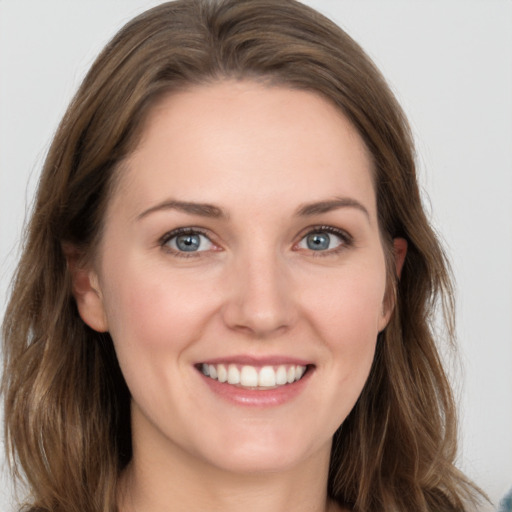 Joyful white young-adult female with long  brown hair and grey eyes