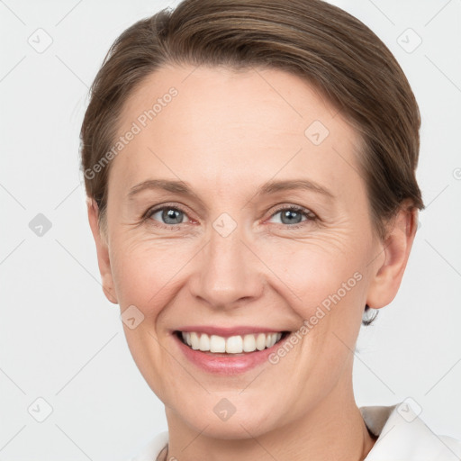 Joyful white adult female with short  brown hair and grey eyes