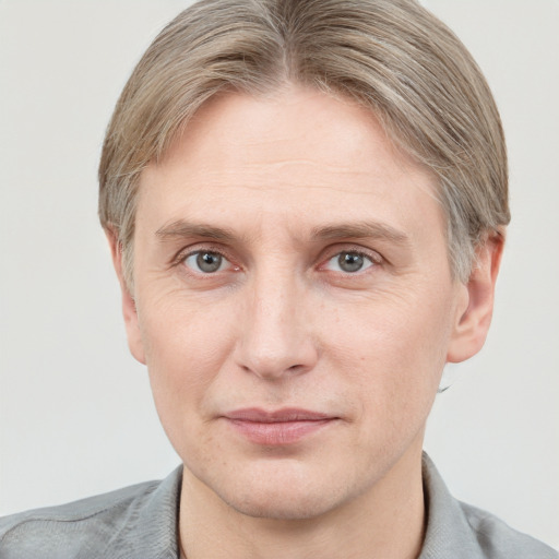 Joyful white adult male with short  brown hair and grey eyes