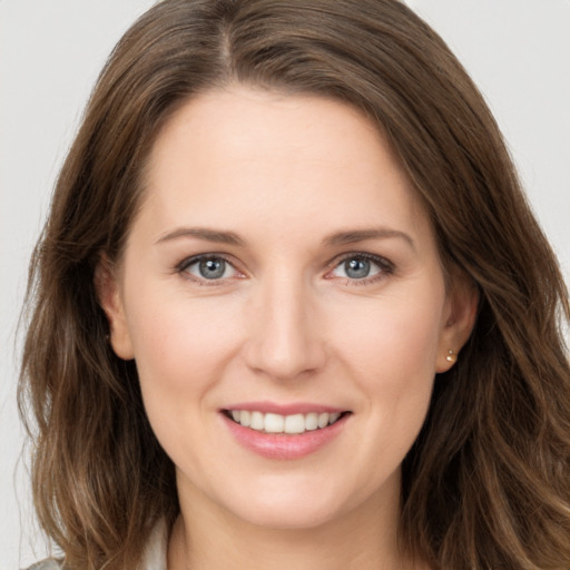 Joyful white young-adult female with long  brown hair and grey eyes