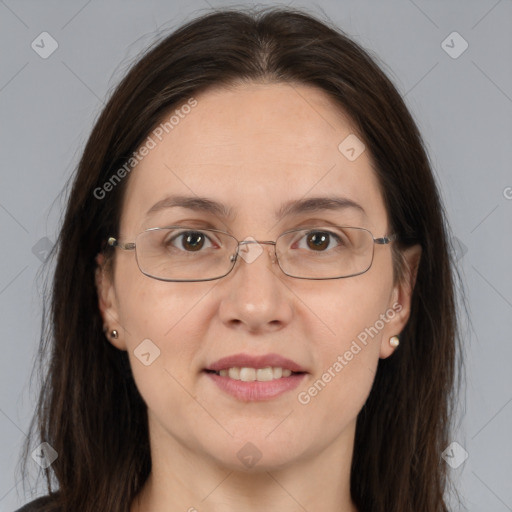 Joyful white adult female with long  brown hair and brown eyes