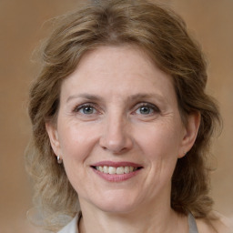 Joyful white adult female with medium  brown hair and grey eyes