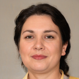 Joyful white adult female with medium  brown hair and brown eyes